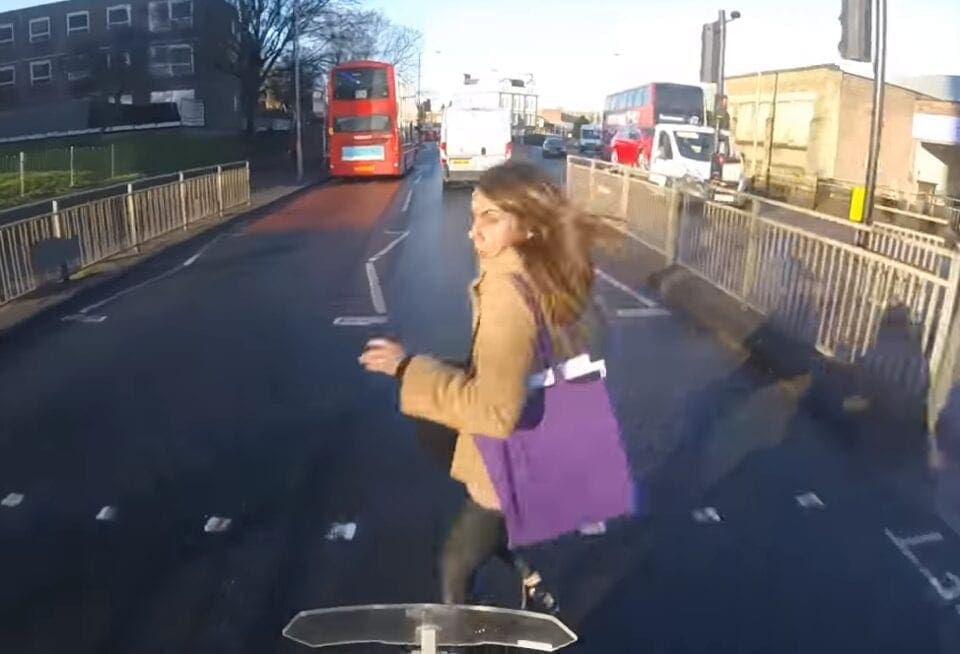 VIDEO: Pedestrian RUNS in front of biker in SHOCKING footage. BOTH escape unharmed.