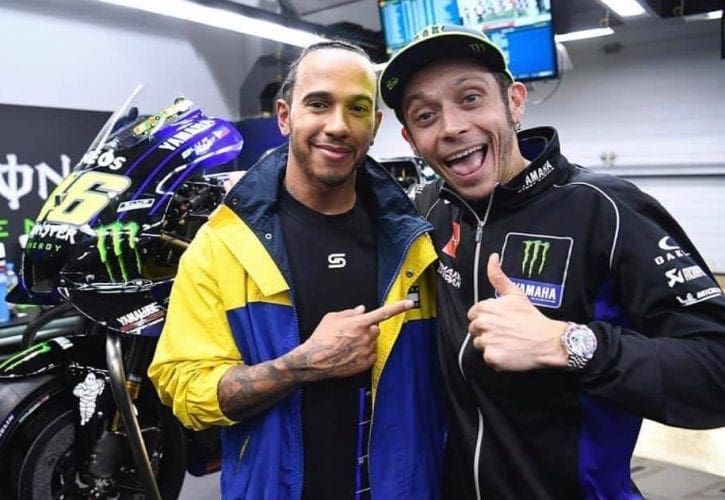 The guy on the left (Lewis Hamilton) is going to ride the guy on the right's (Valentino Rossi) factory Yamaha on December 9. And vice-versa (but swap the word Yamaha for Mercedes). At Valencia.
