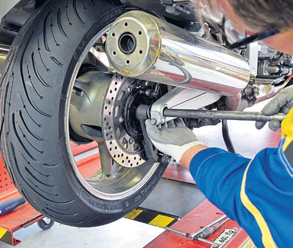 A person working on a motorcycle tyre.