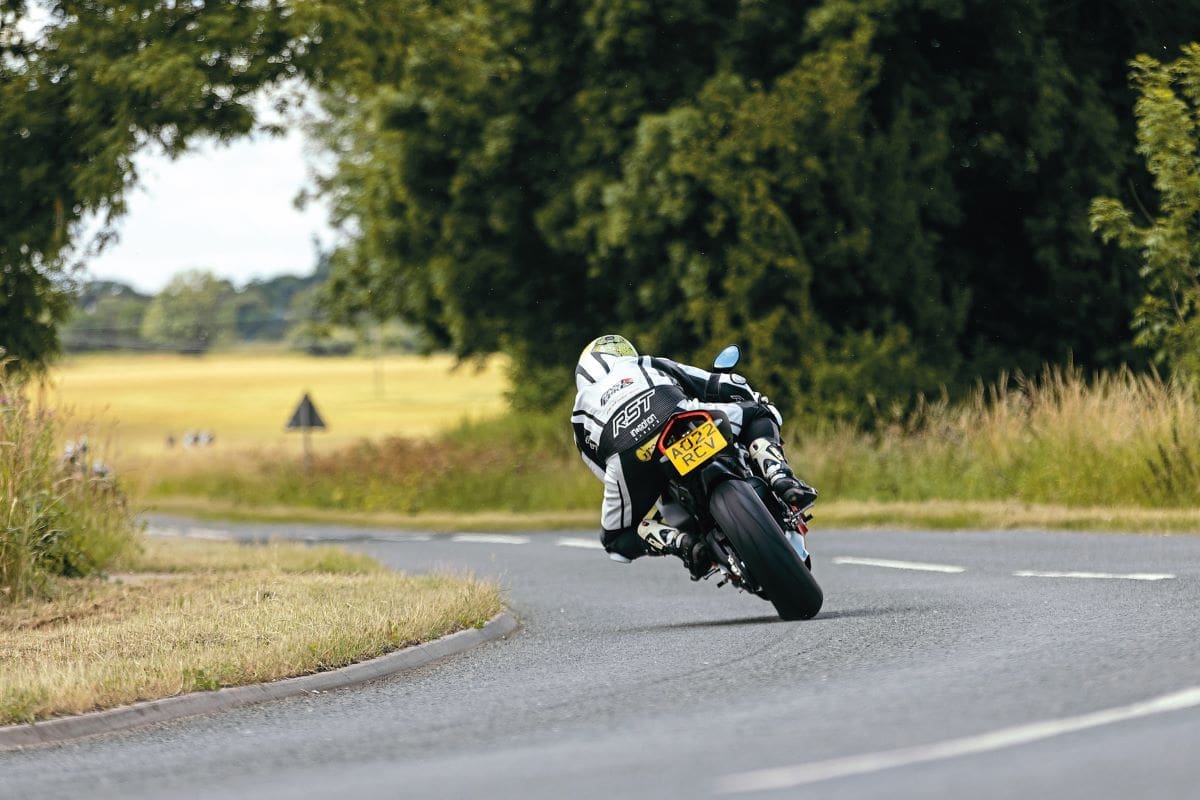 A shot from behind of a rider going around a bend in the road on the Ducati Panigale V4 SP2