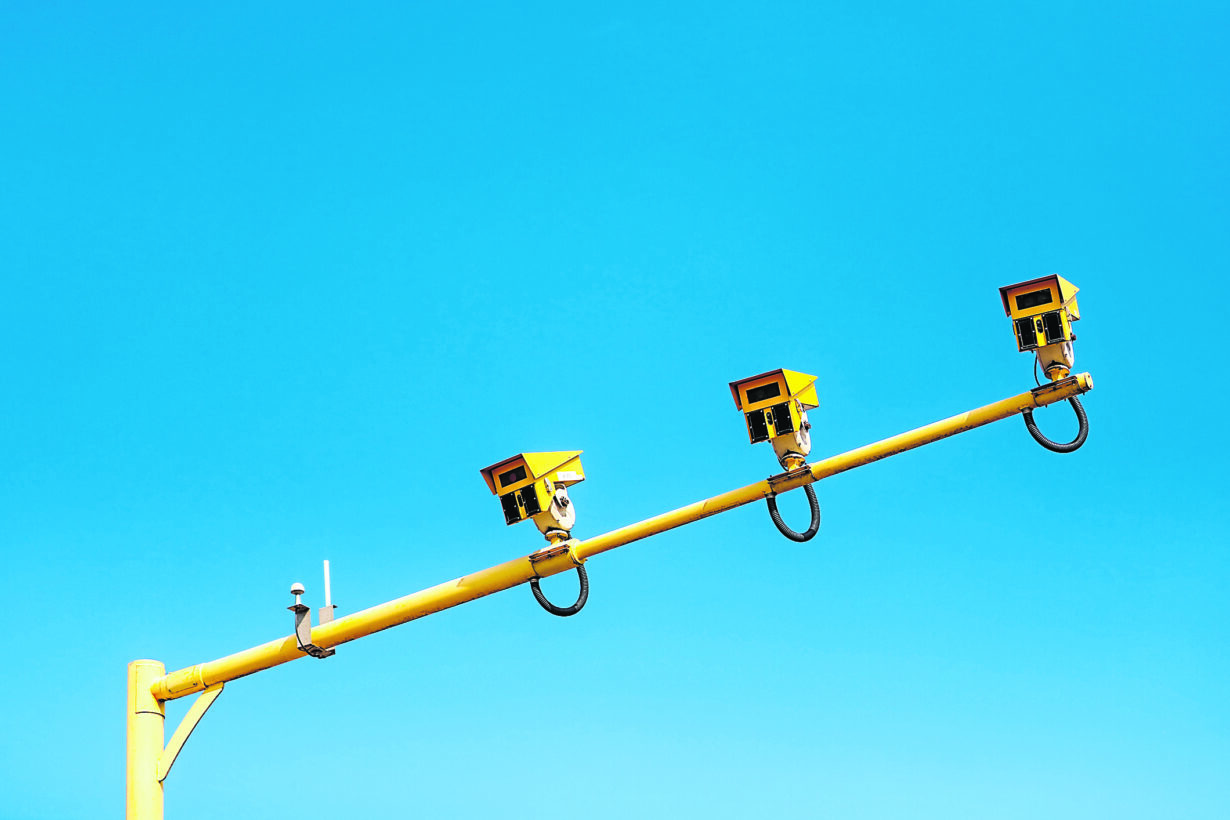 Average traffic speed camera on motorway against a blue sky background