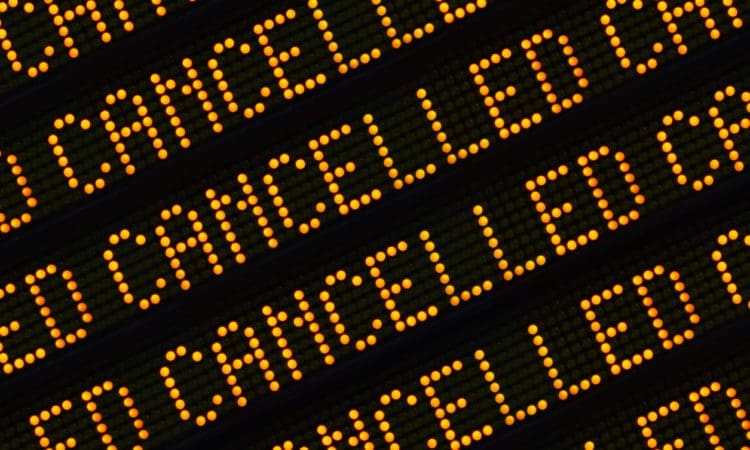 A Close Up Of The Word Cancelled Repeated Multiple Times On A Sign At A Station Or Airport
