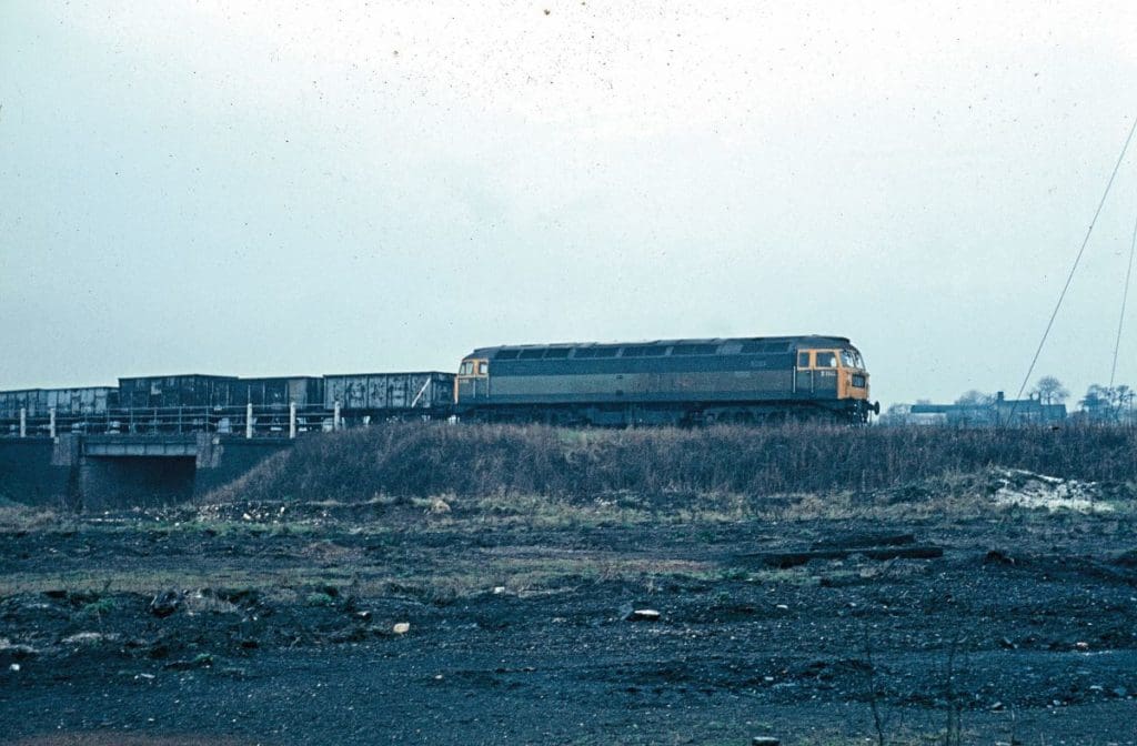 The sixteenth machine to be built, No. D1515 (later 47415) trundles along at an unknown location on February 11, 1968, still in two-tone green livery with some empty two-axle mineral wagons.
