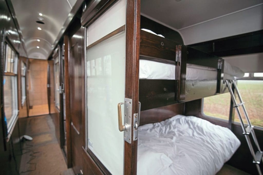 A view through a carriage door of a bunk bed.