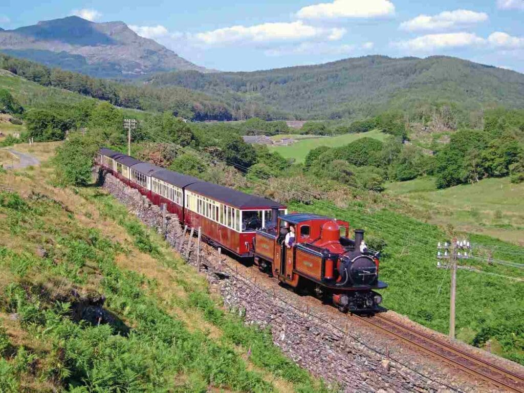 Double Fairlie No. 12 David Lloyd George dates from 1982 and is the most powerful of the type of the line. It is seen heading towards Penrhyn with a Porthmadog-bound train. ROGER DIMMICK/Ff&WHR