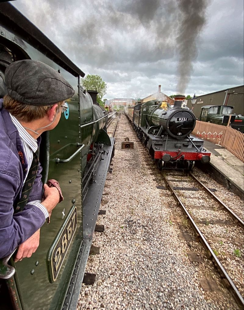 A man looking out a train window at 9351.