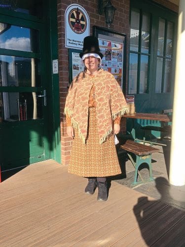 Talyllyn Railway museum guide and shop attendant Kes in period outfit.