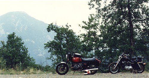 A BMW, a Sportster, and a mountain. The Sportster is the least suitable of the three for sitting on all day.