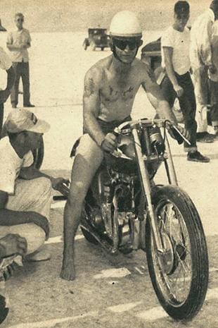 Jack Dale on his Triumph motorcycle wearing the official record-breaker's uniform