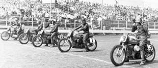 Harley-Davidson v-twins line up for start of dirt track race