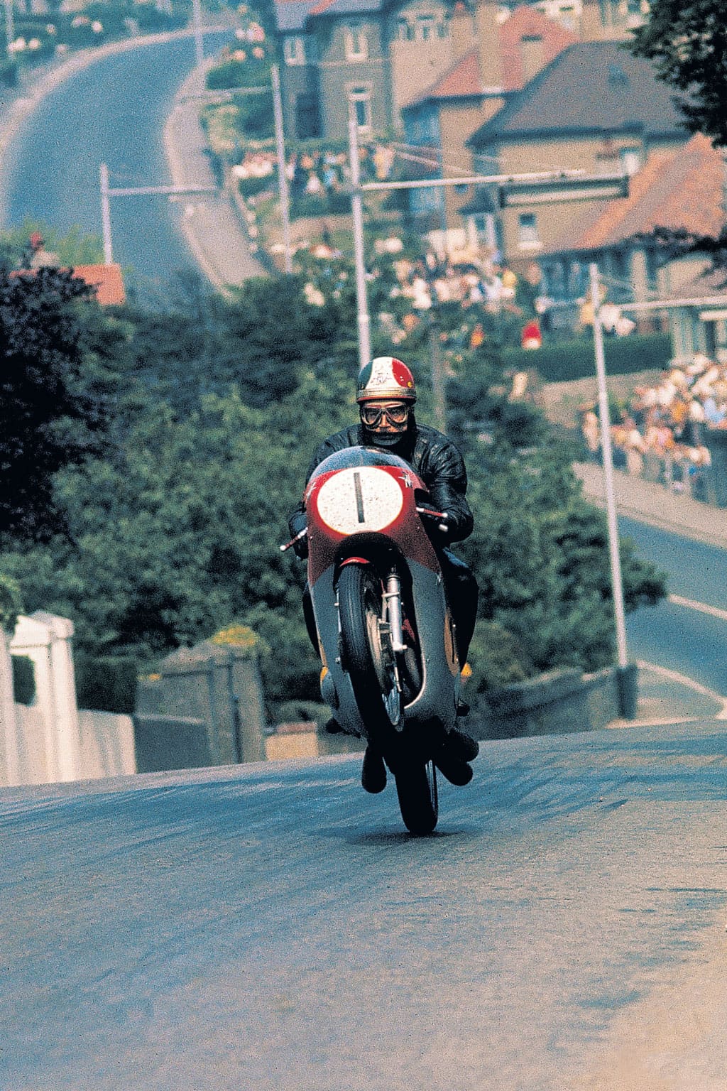 Surely one of the most iconic TT shots, captured by the camera of Nick Nicholls, Italian legend Giacomo Agostini crests the rise at the foot of bray Hill which was forever after know as Ago's Leap.