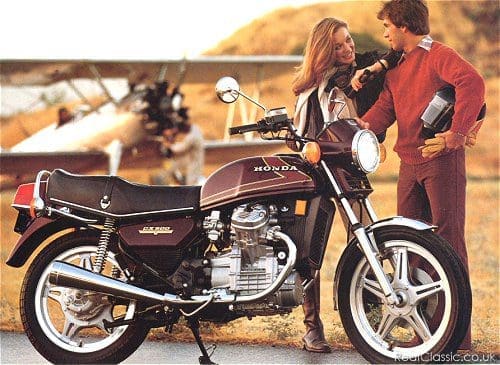 What a brown photo. Brown jumper, brown slacks, brown gloves, brown bike. Although everything else looks so brown, the bike might be purple...