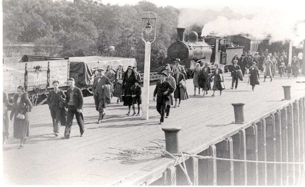 passengers on railway platform after leaving steam train