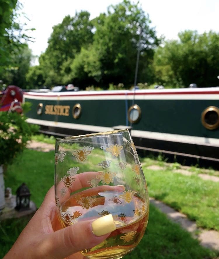 Enjoying a drink next to the narrowboat Solstice