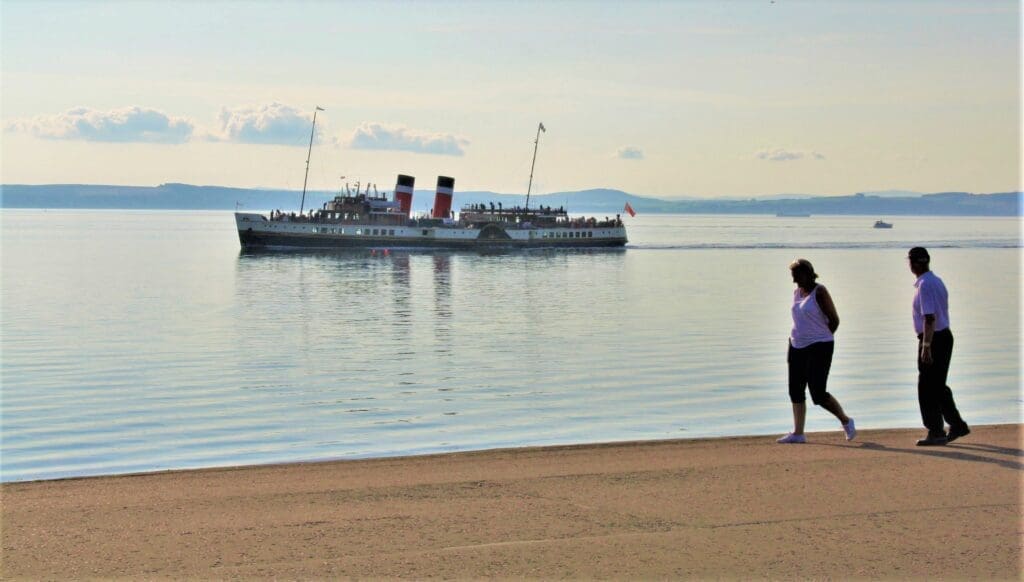 A couple on the shore watch Waverley as she makes for Largs Pier on 22 August. Hugh Dougherty