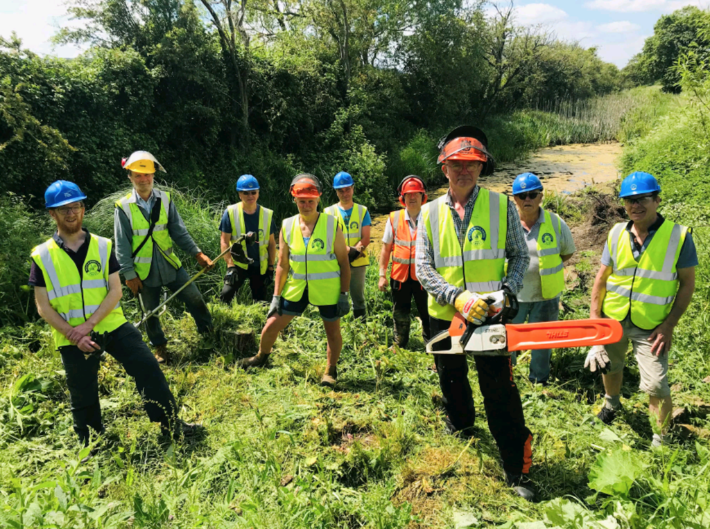 Branch chairman Dave Maloney, front with chainsaw and fellow volunteers clearing the former Wilts & Berks Canal at Green Lane Farm east of Chippenham. PHOTO: JUSTIN GUY
