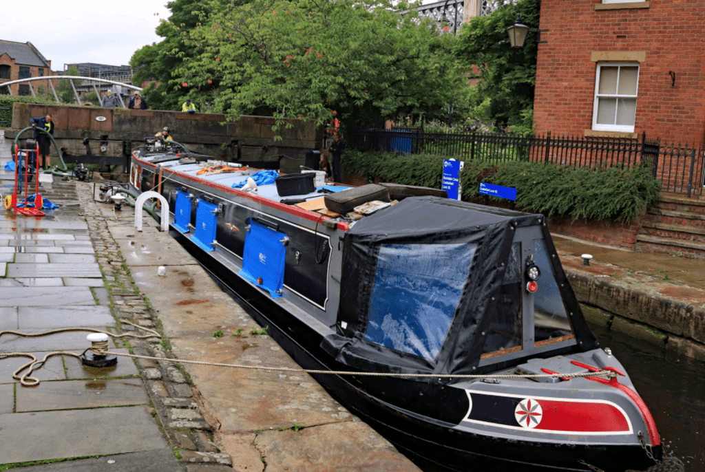 Nearly all the wter has been pumped out of the boat and it sits in the lock as the equipment is started to be tidied up for the return of the RCR vans.