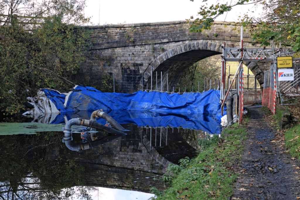 The pumps in the water at Aspen Bridge powered by electricity from a generator at the top of the bank on the left.