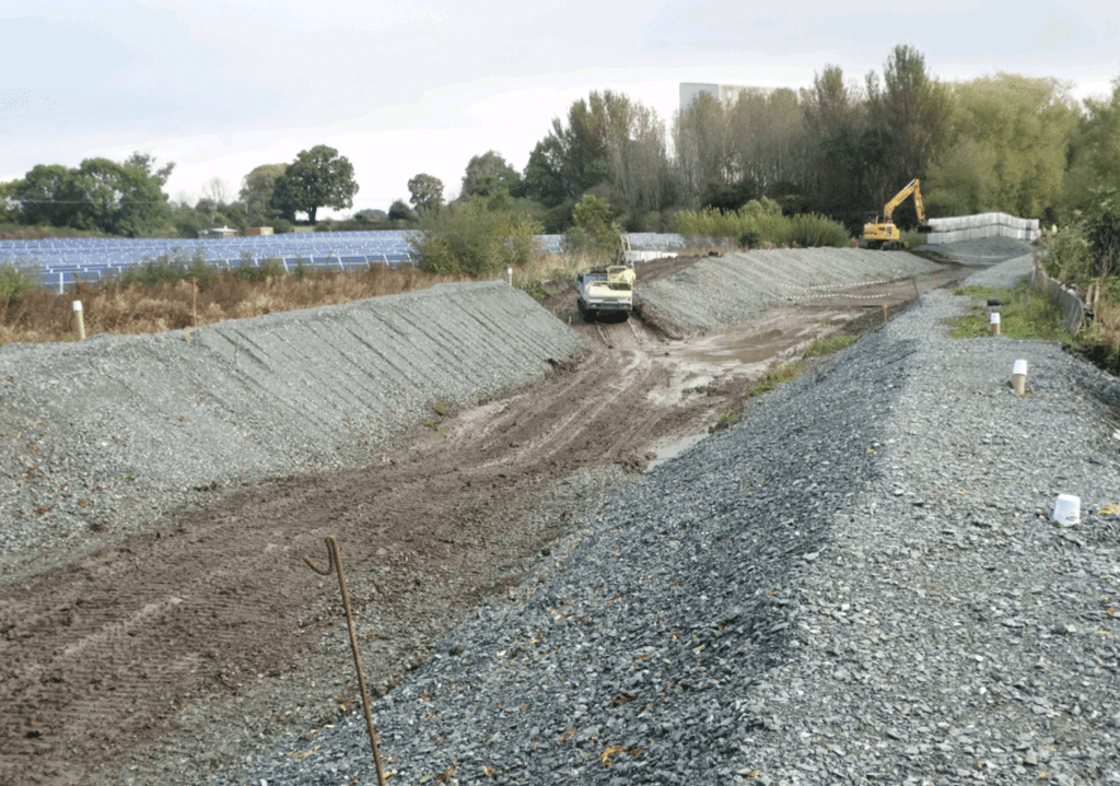 A view of the stone bank and soil being imported.