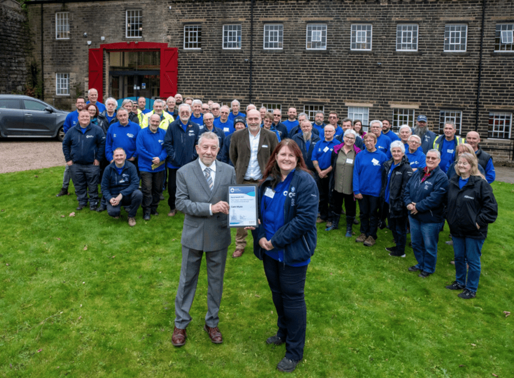 David Booker of the Marsh Charitable Trust presents Cath Munn with her award watched by Canal & River Trust volunteer nominees and staff.