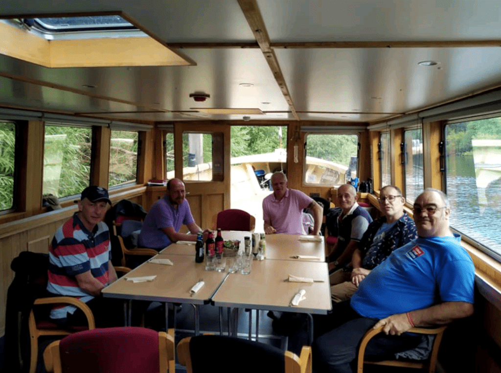 John Joyce, right, with veterans on the River Thames.