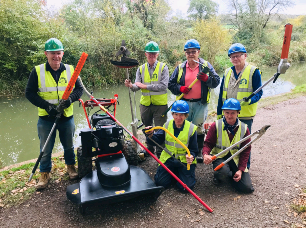 Dave Maloney, second from left and fellow volunteers in front of the restored canal at Pewsham, with some of the new equipment funded by Chippenham Borough Lands Charity.  PHOTO: JUSTIN GUY