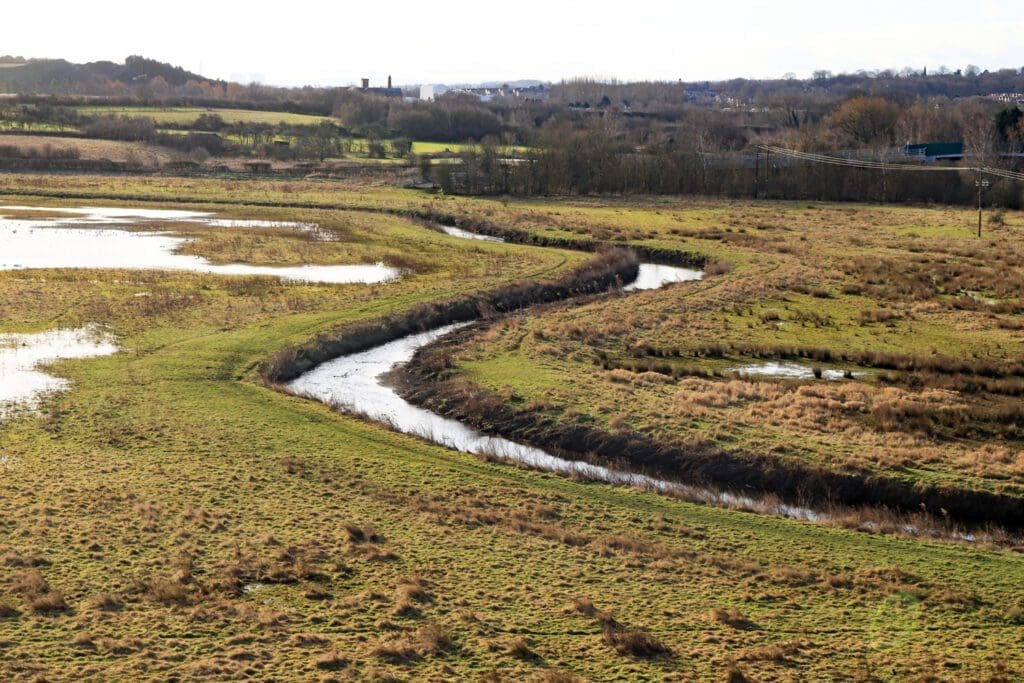 The River Erewash flows towards Nottingham along its valley on the Nottinghamshire and Derbyshire border as seen from the deck of the Iron Giant. Further along the viaduct it crosses the derelict Nottingham canal and at the other end the access ramp drops down onto the towpath of the Erewash canal.