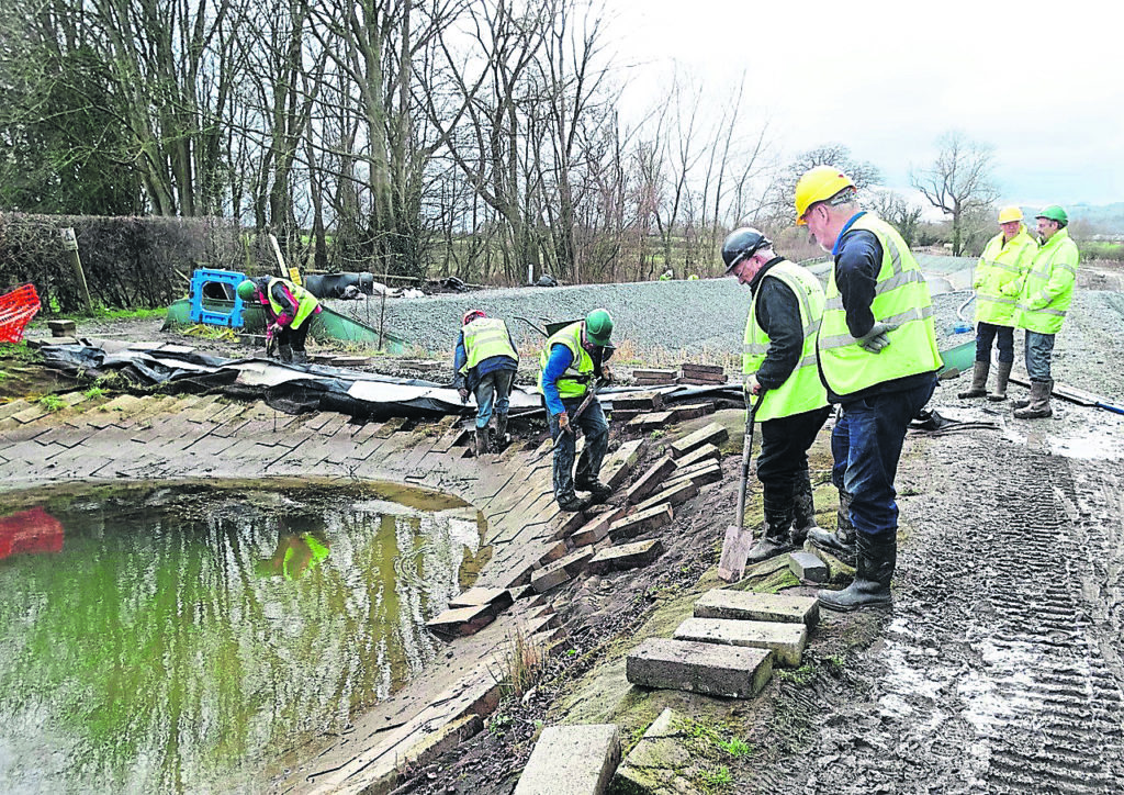 Volunteers removing blocks and liner.