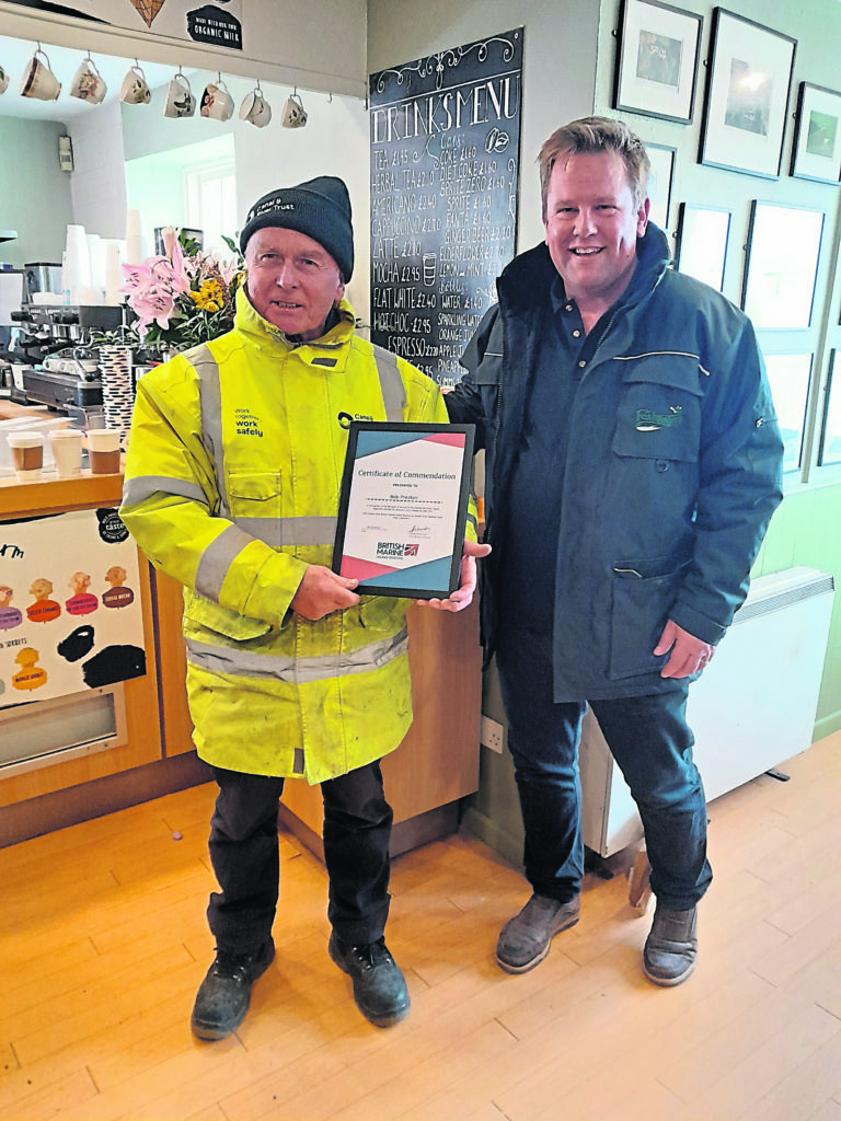 Retiring lock keeper Bob Preston receiving a British Marine certificate of commendation from Russell Fletcher at Foxhangers.