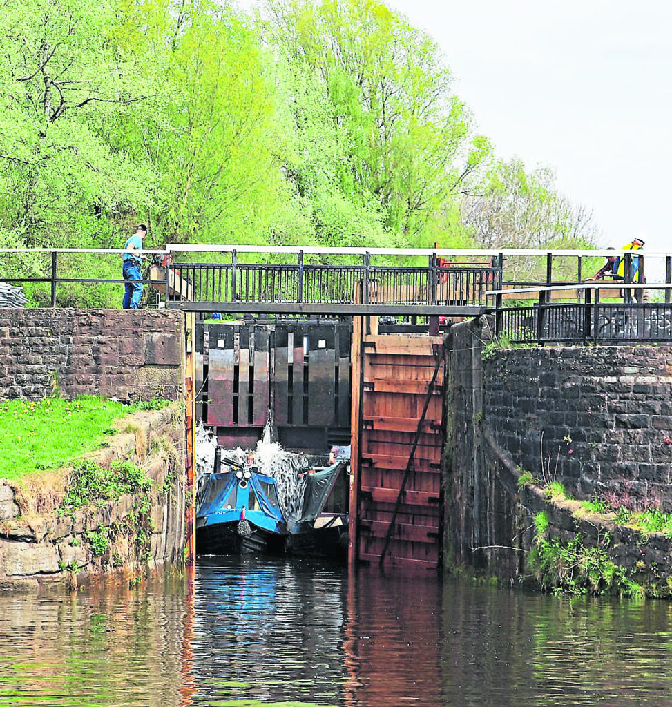 The first two narrowboats down the flight, Bee Happy and Moles about to leave Lock 73.