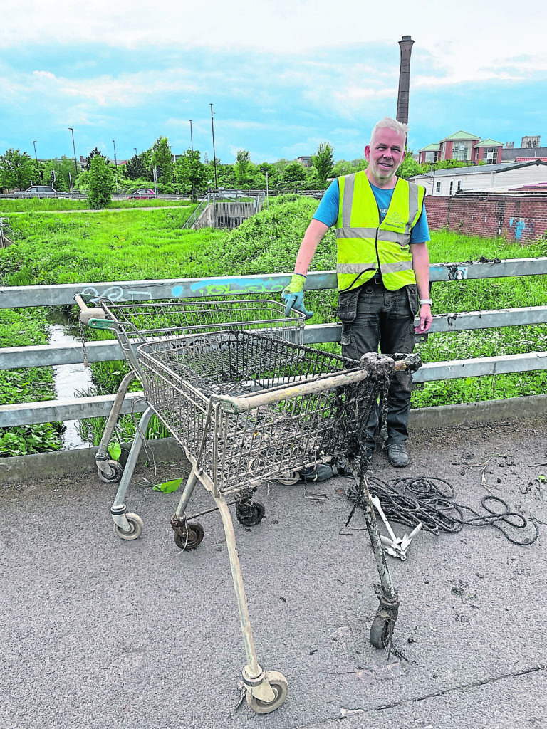 Tim Rane with trolleys 50 and 51 retrieved from the River Foss in York.