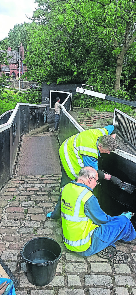 Volunteers painting the bridge.