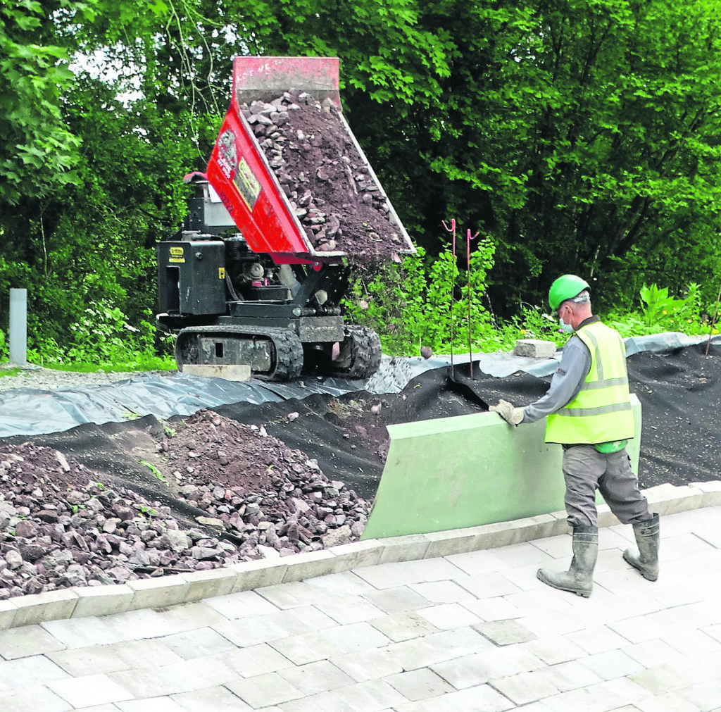 Adding riprap to the embankment.