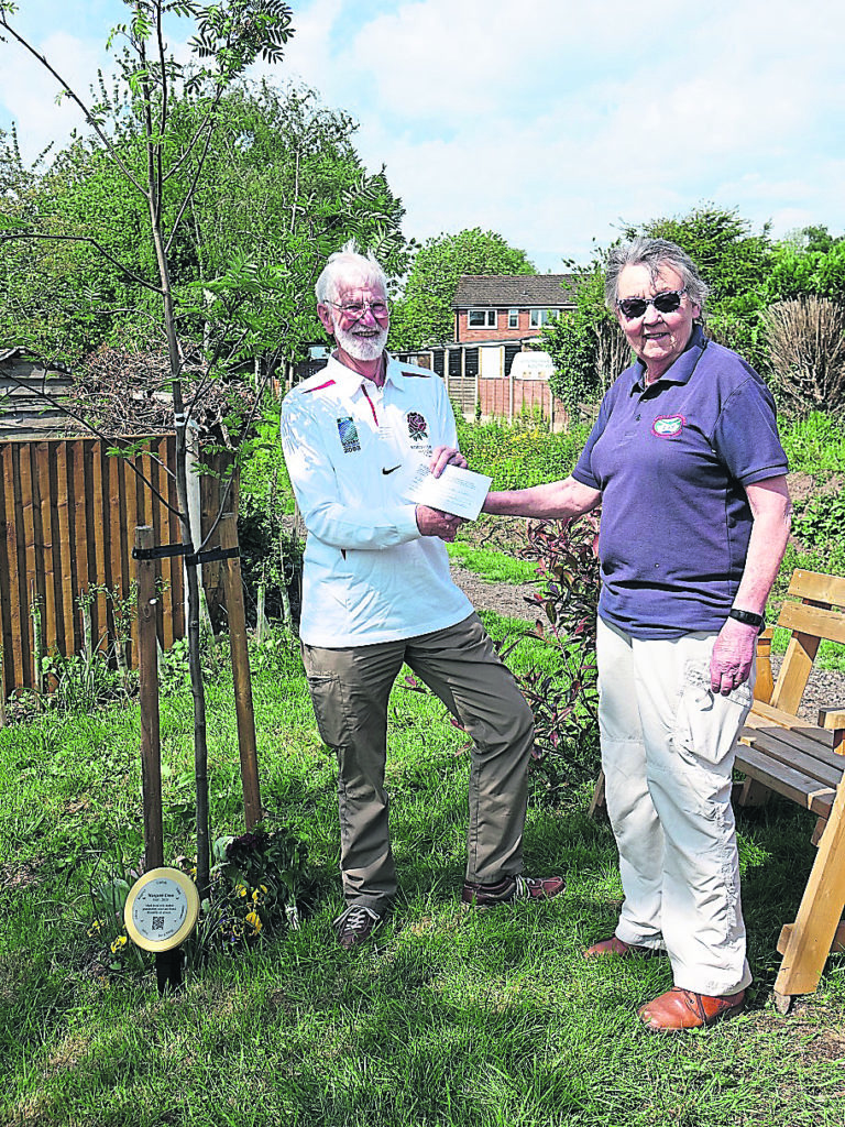 Rob Cross makes a donation to LHCRT chairperson Christine Bull, after the dedication of a rowan tree in memory of his wife Margaret. PHOTO: LHCRT