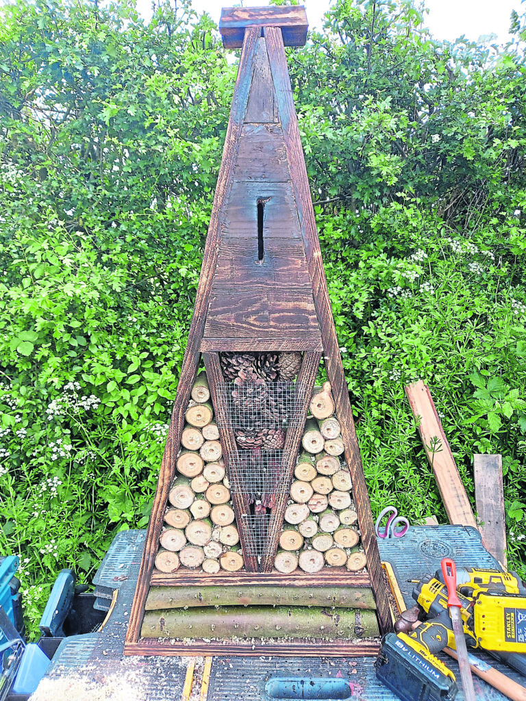 An insect hotel handcrafted from reclaimed wood.