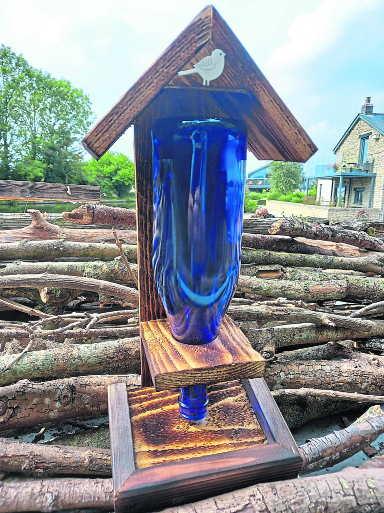 A gravity-fed feeder using an inverted bottle.