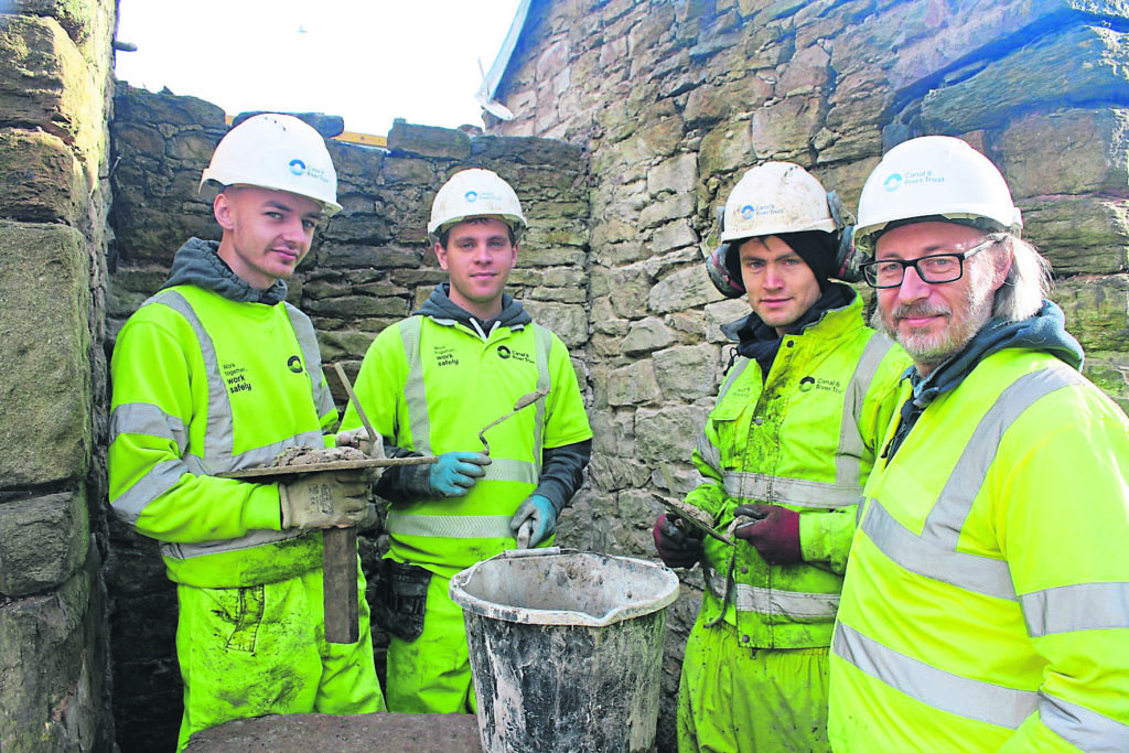 Finsley Gate apprentices Dominic Lafrenz and Tyler Williams with James Archer and heritage adviser Bill Froggatt at the washhouse restoration.