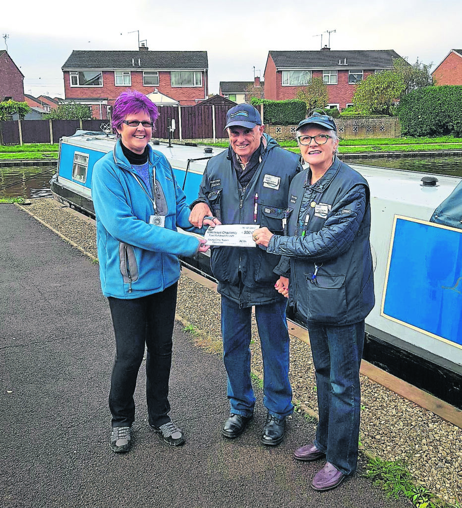 RCTA chairman Sue Meaders presenting the donation to waterways chaplains Malcolm and Stephanie Grey-Smart.