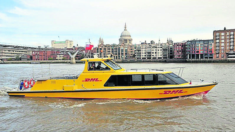 DHL express parcels riverboat on the Thames with St Paul’s in the background.