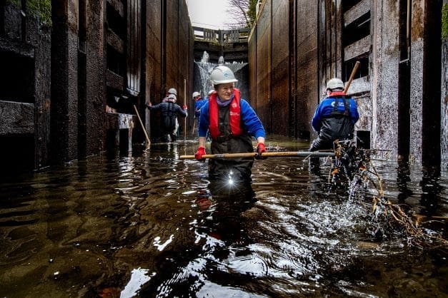 Volunteer Maureen Readle removes debris from Tuel Lane Lock,the Uk's deepest lock chamber.