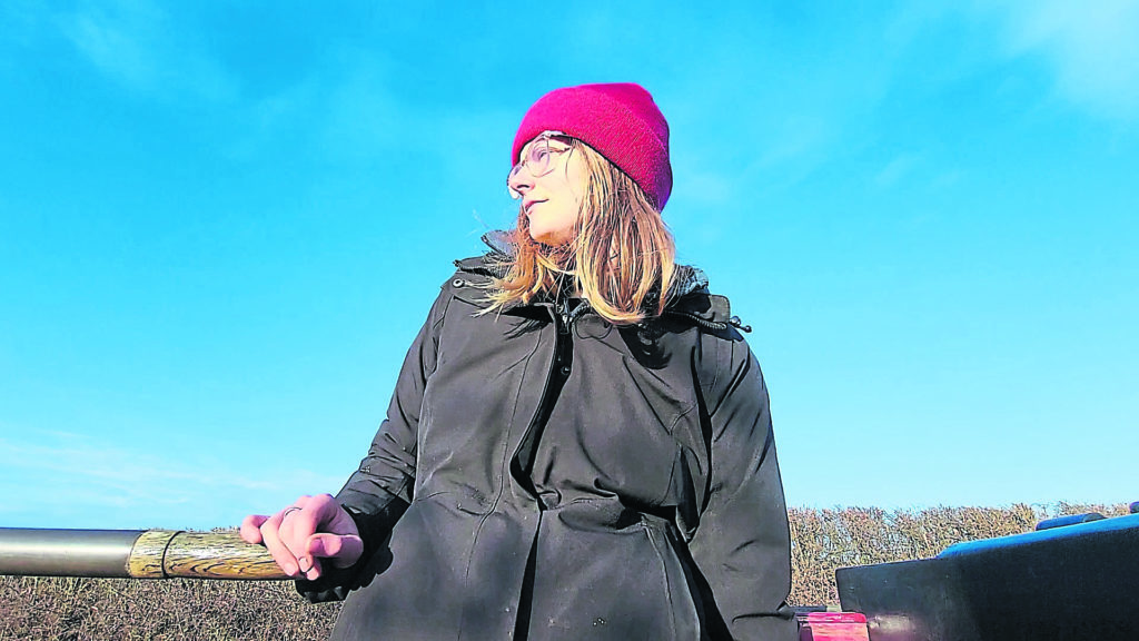 May at the tiller of her narrowboat.