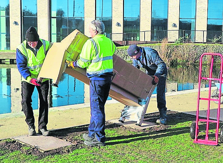 Lifting one of the benches into place.