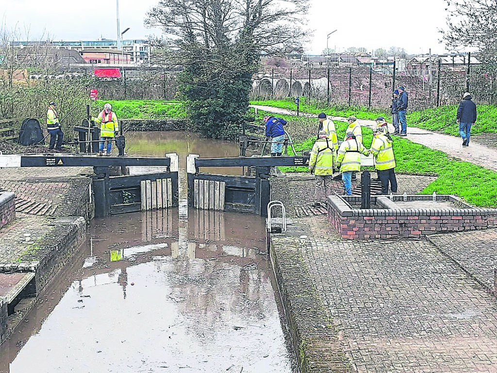 Volunteers working on the gates at Firepool Lock. PHOTO: IWA