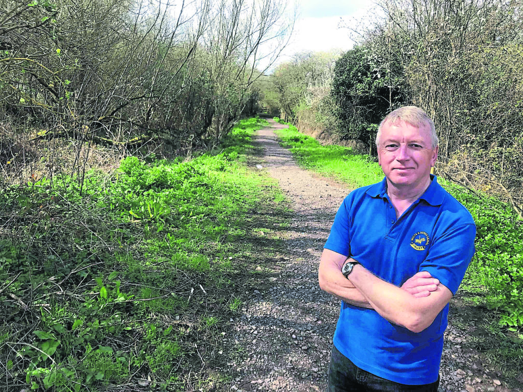 Work party organiser Howard Wilson on the towpath near Reybridge, with the overgrown canal to the left. PHOTO: JUSTIN GUY