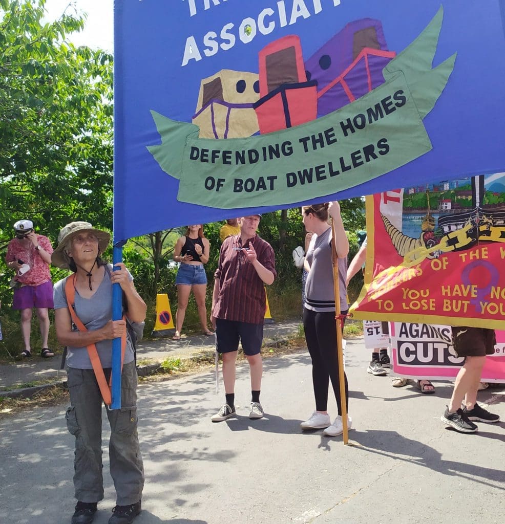 Pamela Smith, chair of the NBTA, holding the NBTA banner at Tolpuddle Martyrs Festival, 2022. Photo supplied by the NBTA.