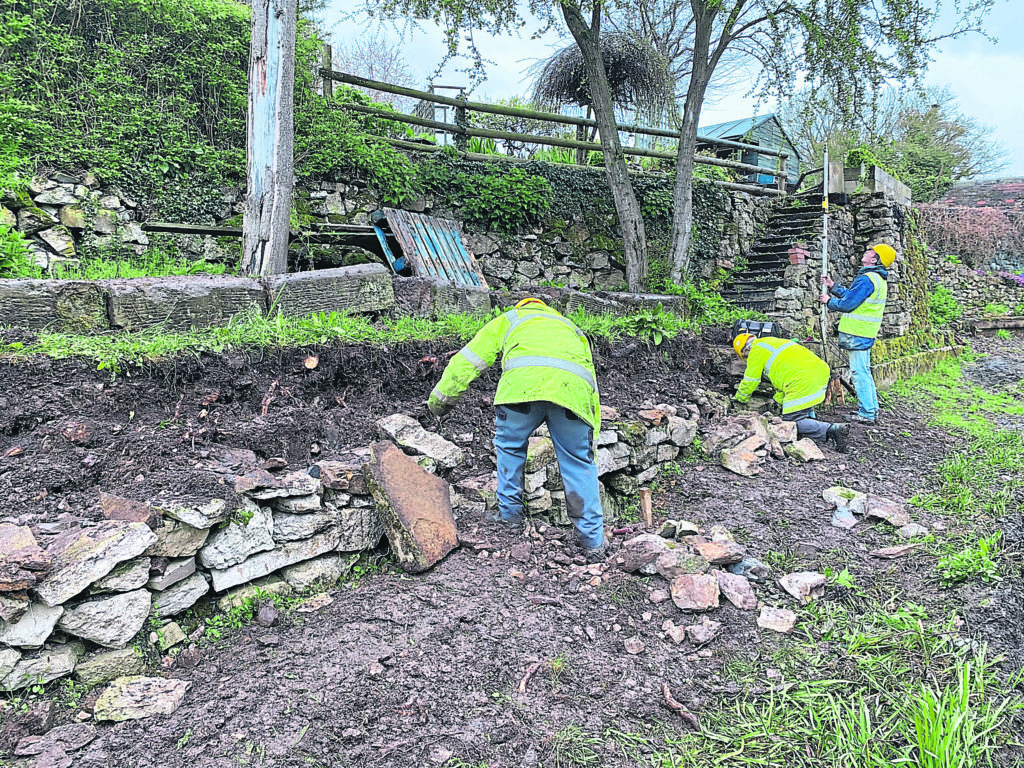 Working on the wharf dry stone wall restoration. PHOTOS: SUCS PUBLICITY