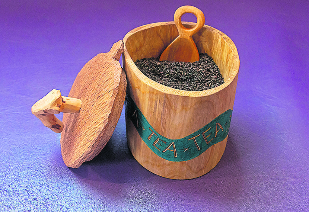 A shrink pot tea caddy with scoop.