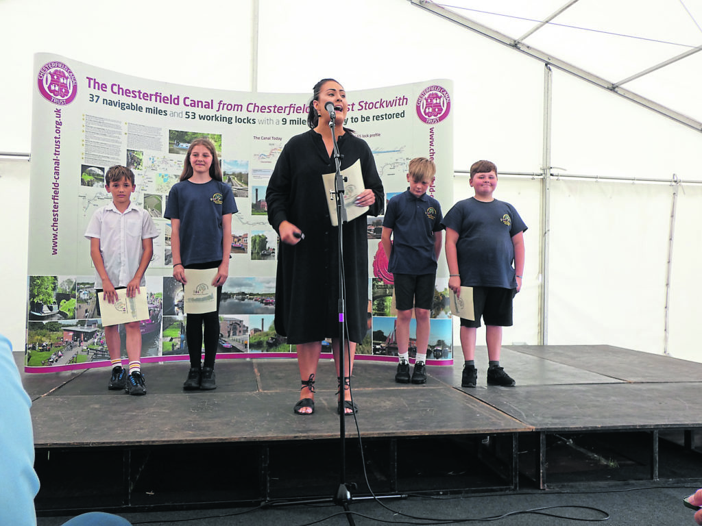 Deputy head Lois Clarke and the young speakers from Hollingwood Primary School.