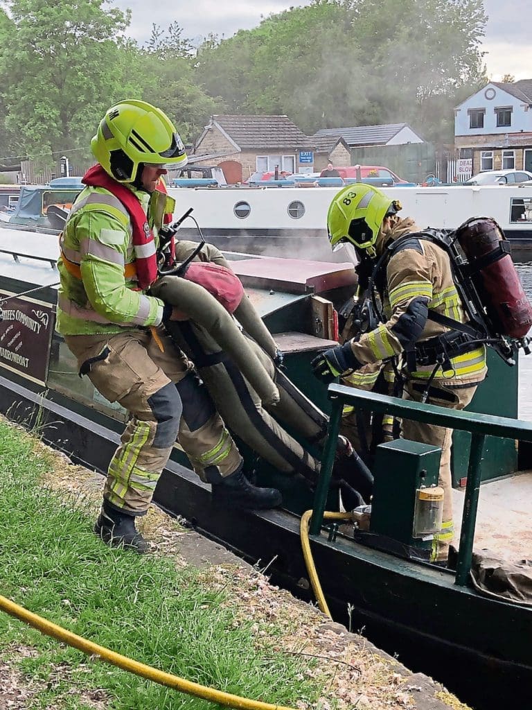 One of the lifeless dummies is recovered by firefighters during the training exercise.