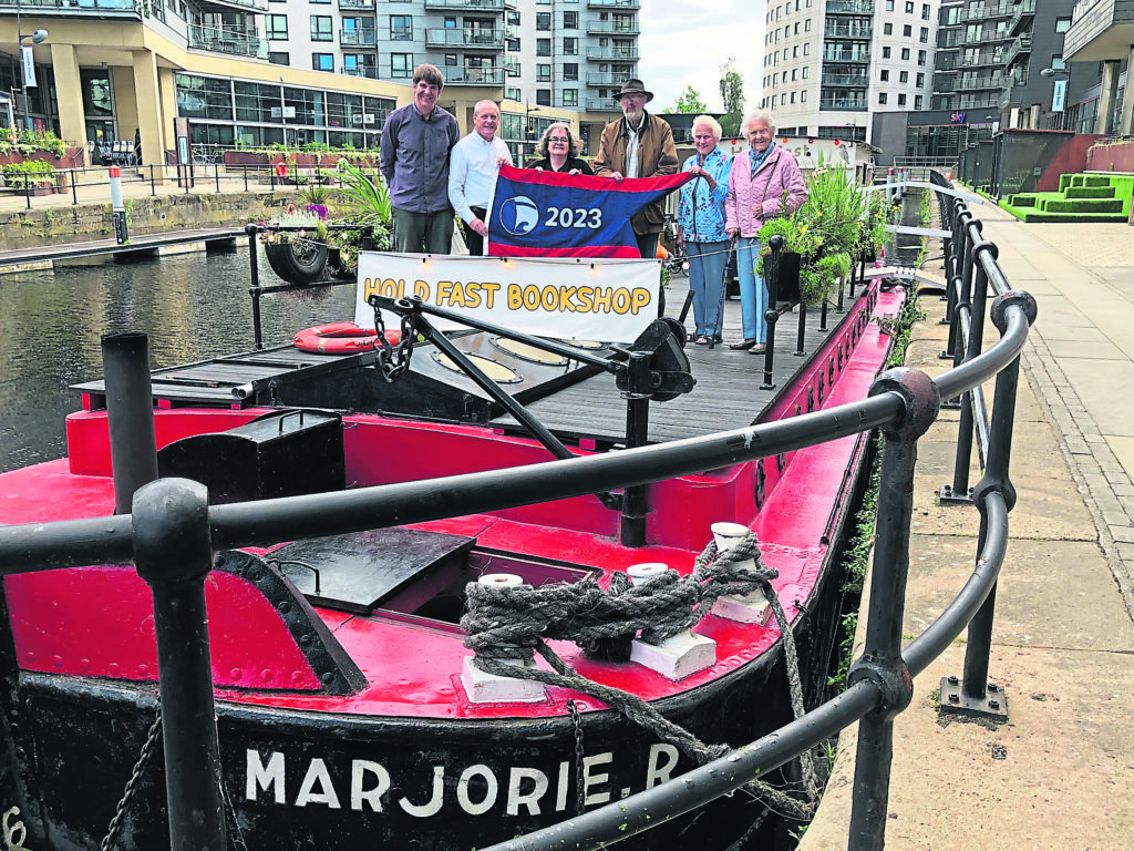 Holding the flag fast are, from left: Chris Bonner, Simon Stephens, Victoria Bonner, Peter Claxton, Sue Grafton and Ann Simpson. 